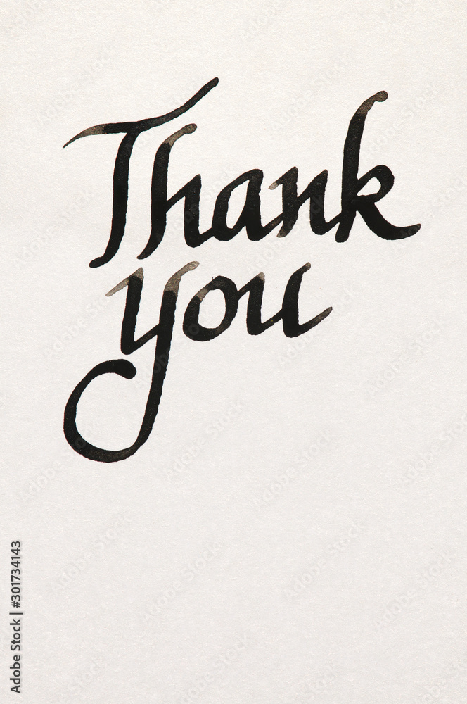 Thank you message handwritten in fresh black ink on textured white paper