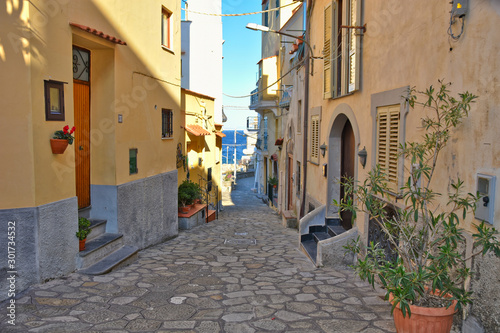 Massa Lubrense, Italy, 12/05/2017. A narrow street among the houses of a fishing village photo