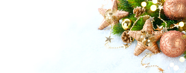 Gold vintage Christmas and New Year Decoration isolated on white background. Border art design with holiday baubles. Beautiful Xmas tree closeup decorated with balls, tinsel, cones. Space for text