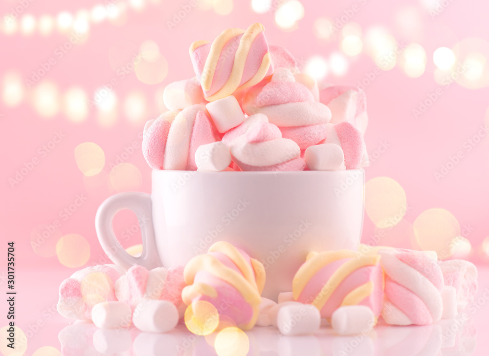 Marshmallow. Close-up of Marshmallows colorful chewy candy, over pink bokeh background, closeup. Sweet holiday food dessert in a cup with hot chocolate close-up. Candies