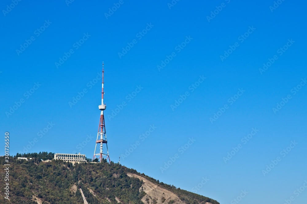 Obraz premium Television broadcasting tower on Mtatsminda Hill in Tbilisi, Georgia. This is a popular tourist attraction in the city. 