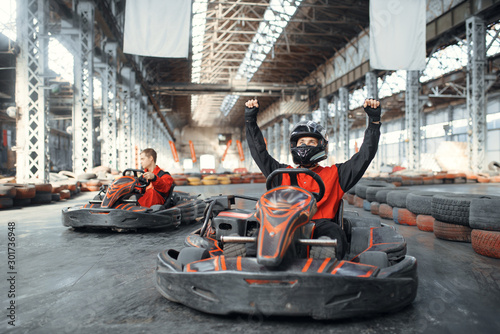 Billede på lærred Go kart racer raised his hands up, front view