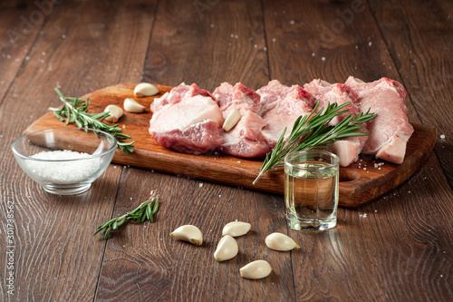 Fresh steak loin of raw meat and spices and a knife lies on a wooden background. copy space