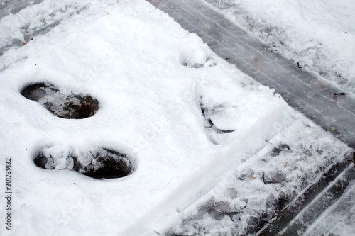 Traces of footwear and tire tracks on the snow surface photo