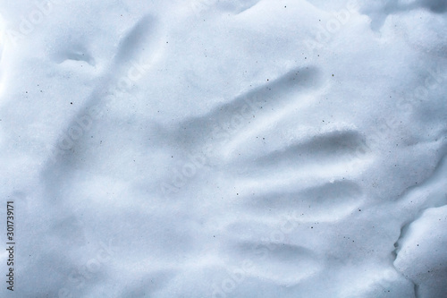 Imprint palm person on the snow surface