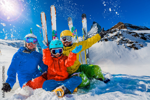 Happy family enjoying winter vacations in mountains . Ski, Sun, Snow and fun.