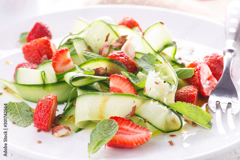 light summer detox salad with strawberries, cucumber, nuts and flax seeds light summer detox salad with strawberries, cucumber, nuts and flax seeds