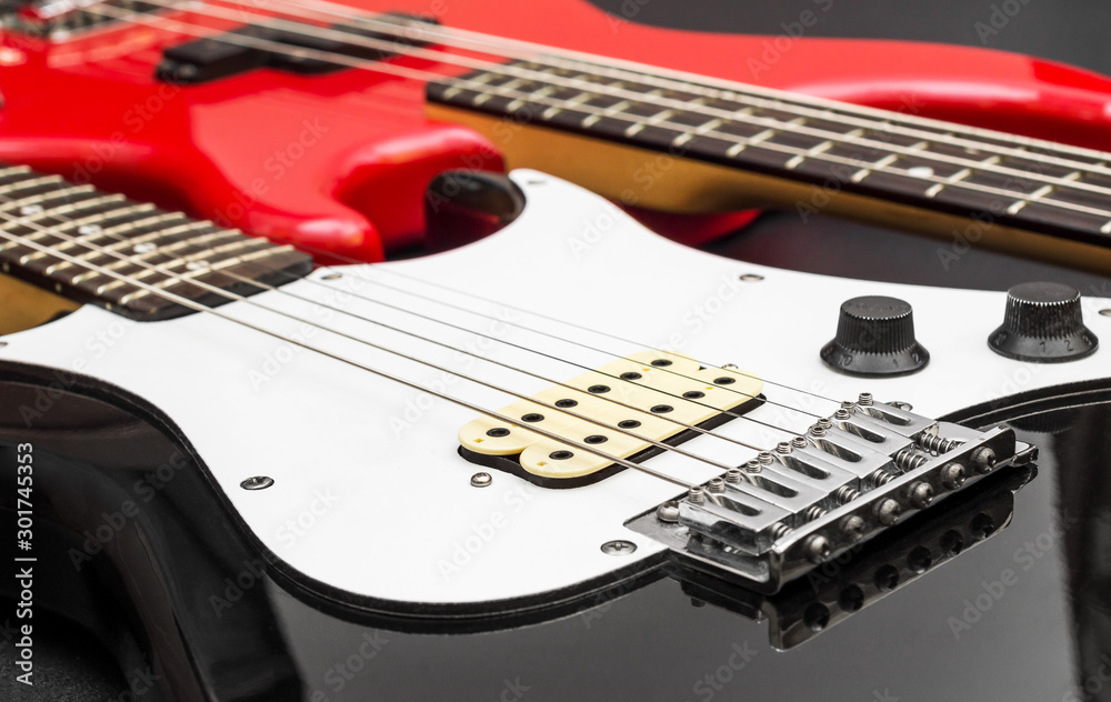 Fototapeta premium Two electric guitar on black background.