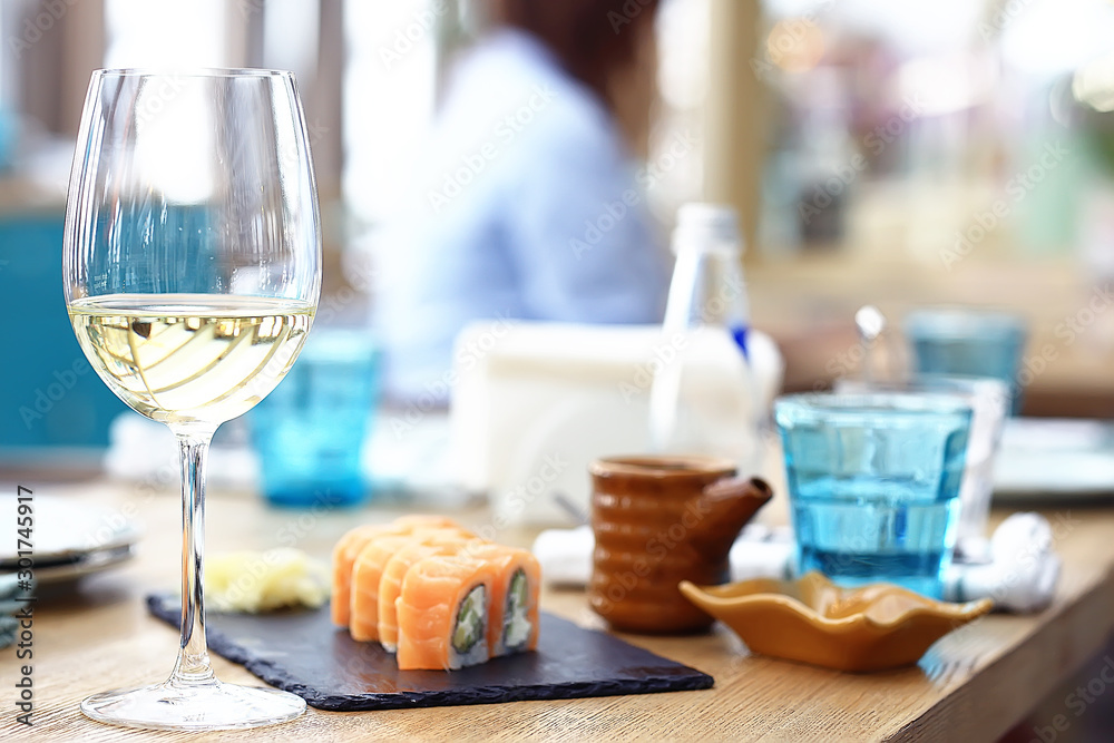 glass of white wine in the restaurant / white wine in the interior of the restaurant a table with glasses of wine, a romantic summer