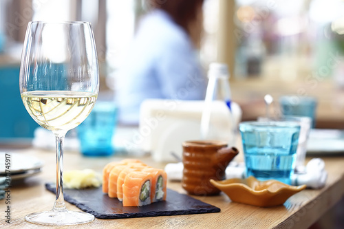 glass of white wine in the restaurant / white wine in the interior of the restaurant a table with glasses of wine, a romantic summer photo