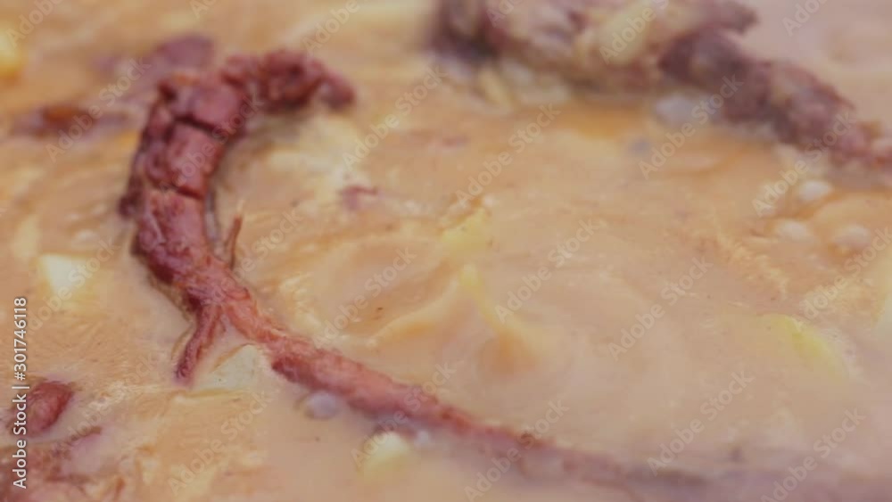 Street Food. stew pork ribs in sauce with onions being cooked over hot charcoal fire and in a big pan Street Food. stew pork ribs in sauce with onions being cooked over hot charcoal fire and in a big pan