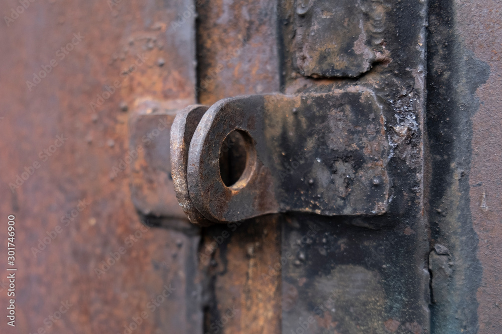 A close up shot of an old rusted key on a metal door keyhole. A close up shot of an old rusted key on a metal door keyhole.