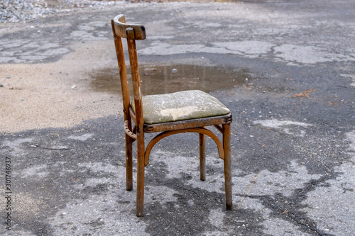 Vintage worn out chair on the street.