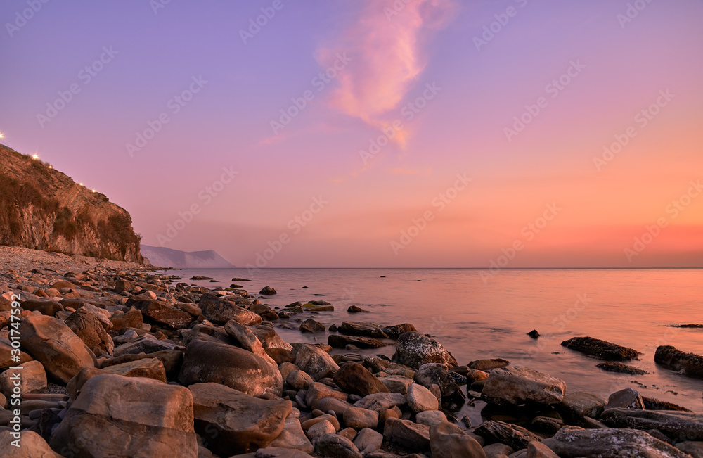 black sea coast at sunset, mountains and stones