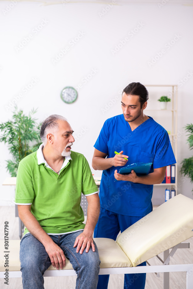 Old man visiting young male doctor gastroenterologist Old man visiting young male doctor gastroenterologist