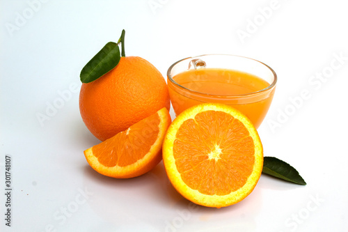 glass of orange juice and oranges isolated on white background