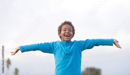 Happy african child opening his arms