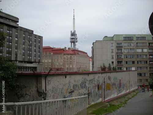Canvas Print popular neighborhood with concrete buildings, a wall and an antenna tower, Pragu