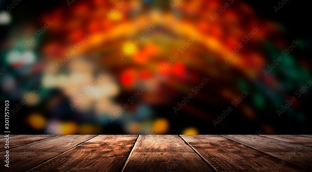 Wooden table, blurred bokeh background background. Neon light, night view, close-up. The general background of the interior, a dark background. Wooden table, blurred bokeh background background. Neon light, night view, close-up. The general background of the interior, a dark background.