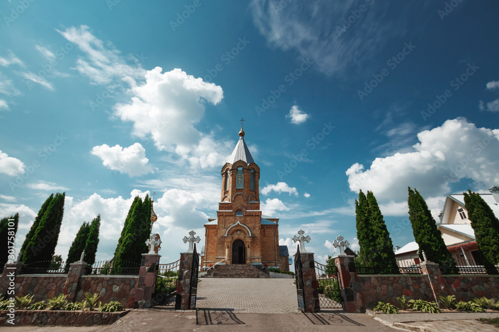 Obraz premium Wedding accessories and interior in Saint Trinity Orthodox Convent including two candlesticks with many candles, flowers, icons and Holy Bible. Wonderful church in Riga, Latvia