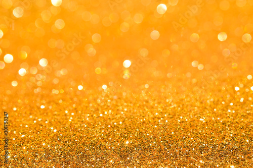 shine and sparkle of golden glitter abstract background	