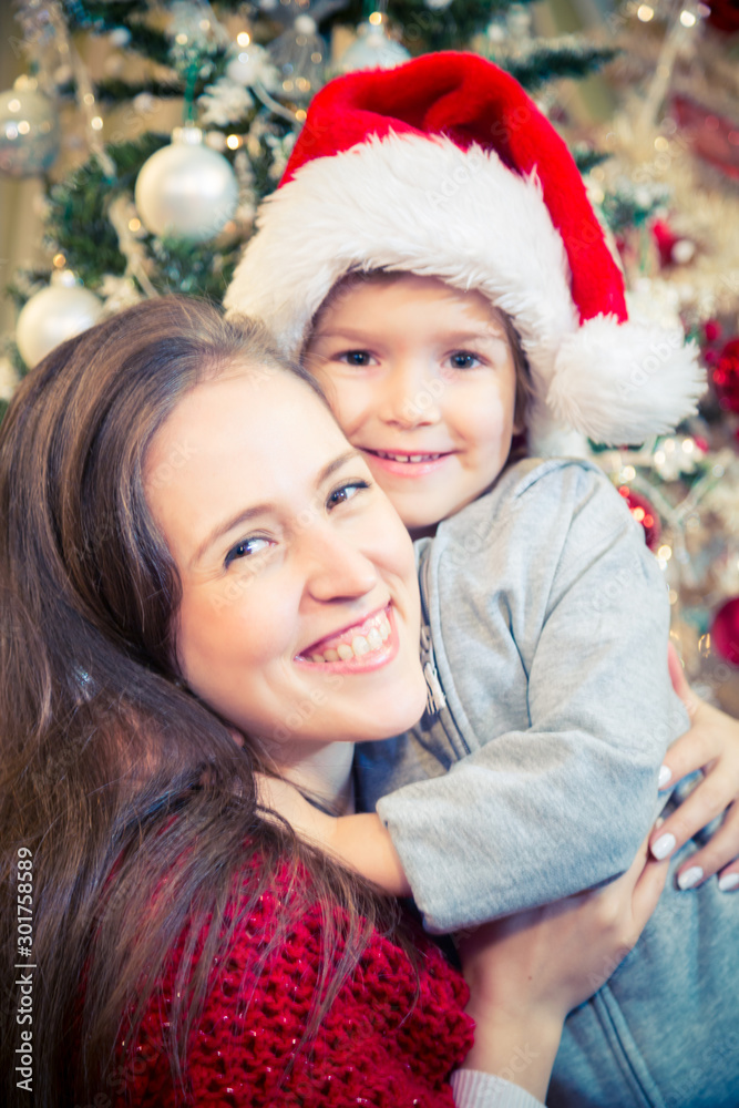 Happy mother and son embracing on Christmas day at home. Happy mother and son embracing on Christmas day at home.