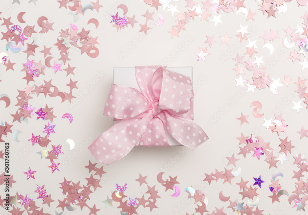 A gift box with confetti on a white background A gift box with confetti on a white background