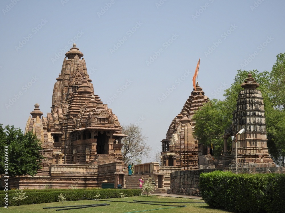 Beautiful image of Kandariya Mahadeva temple, Khajuraho, Madhyapradesh, India with blue sky and fluffy clouds in the background, world famous ancient temples in India, UNESCO world heritage site.