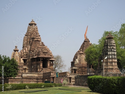 Beautiful image of Kandariya Mahadeva temple, Khajuraho, Madhyapradesh, India with blue sky and fluffy clouds in the background, world famous ancient temples in India, UNESCO world heritage site. photo