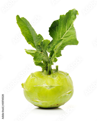 Fresh kohlrabi with green leaves on isolated white backround