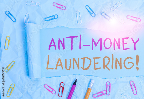 Conceptual hand writing showing Anti Money Laundering. Concept meaning regulations stop generating income through illegal actions Stationary and torn cardboard on a plain pastel table backdrop