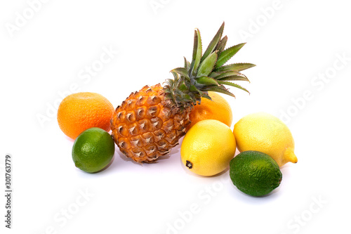 Pineapple with lemon and lime and oranges on a white background. Group of citrus fruits close-up. Lime green, pineapple, orange orange, lemon close-up on an isolated white background.