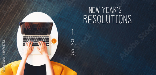 New years resolution with person using a laptop on a white table