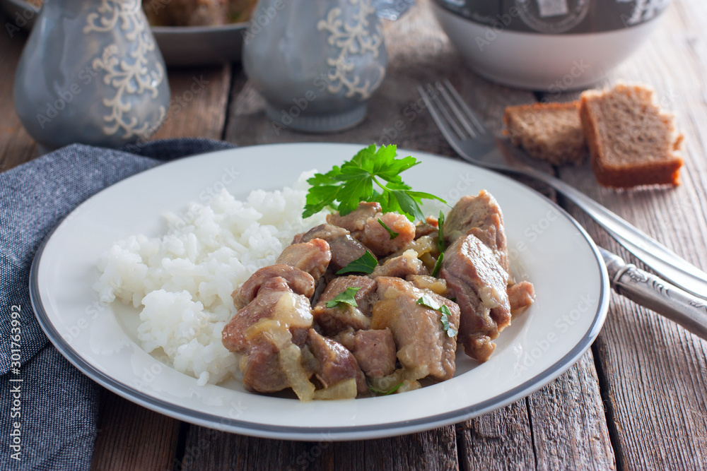 Sliced turkey thigh fillet meat on a wooden table, horizontal Sliced turkey thigh fillet meat on a wooden table, horizontal