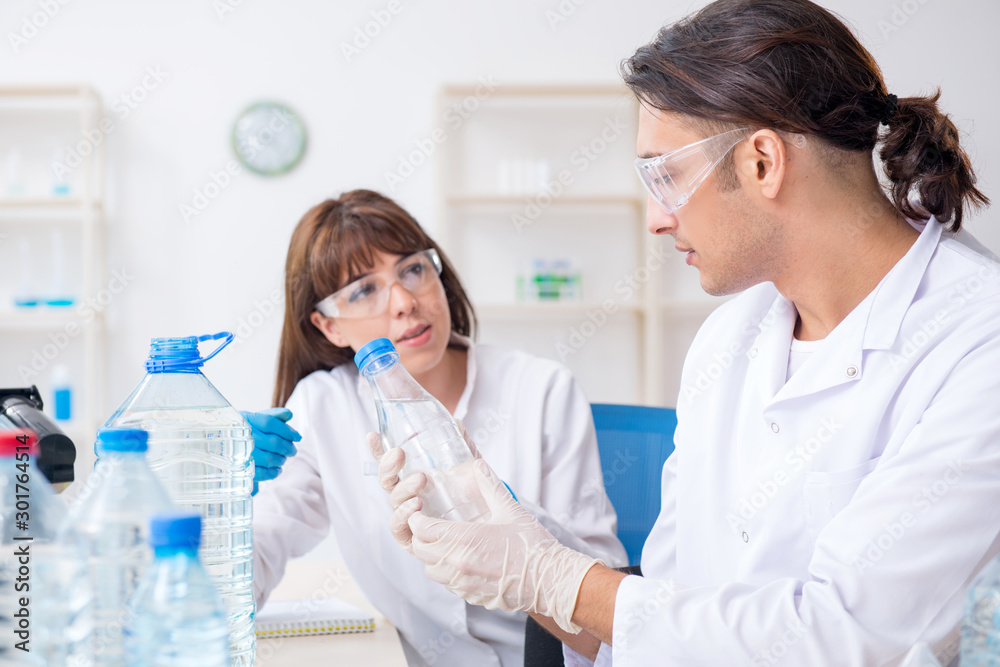 Two chemists working in the lab Two chemists working in the lab