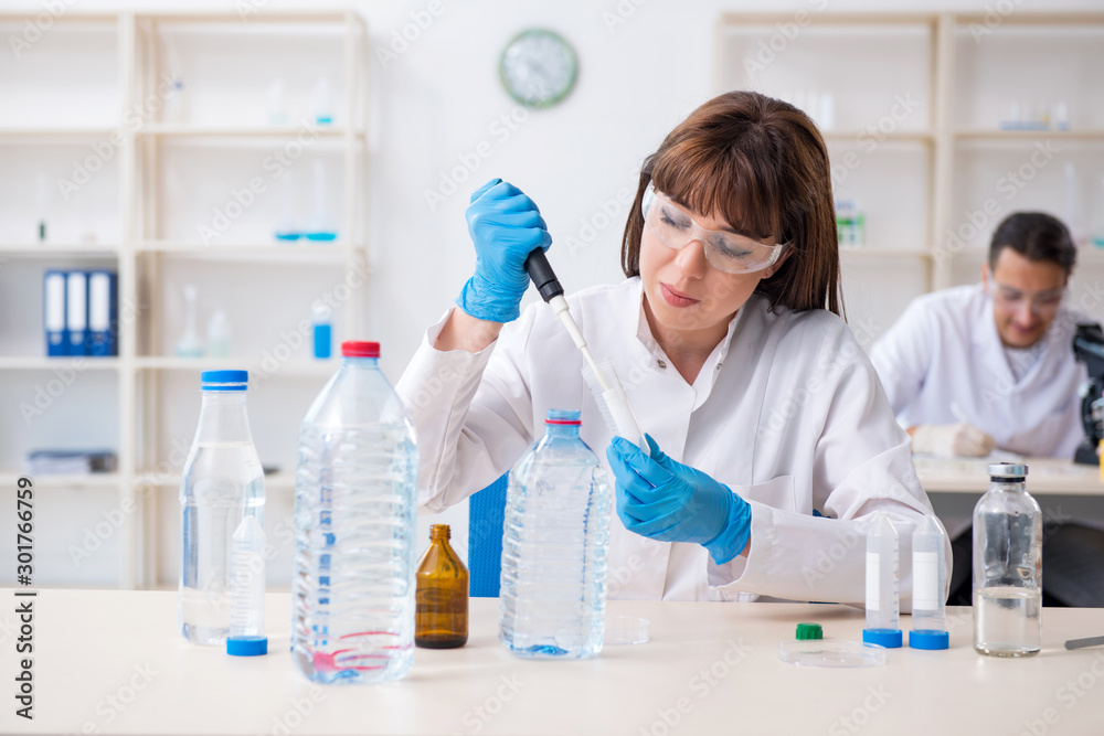 Two chemists working in the lab Two chemists working in the lab