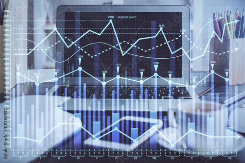 Financial chart drawing and table with computer on background. Multi exposure. Concept of international markets. © peshkova