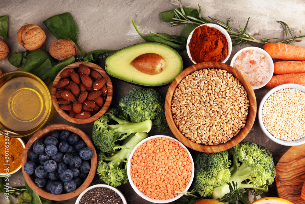 Healthy food clean eating selection: fish, fruit, vegetable, cereal, leaf vegetable on rustic background Healthy food clean eating selection: fish, fruit, vegetable, cereal, leaf vegetable on rustic background