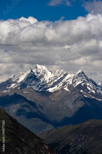 Landscape of Siguniang mountain or Four girls mountains with snow cap on top and  plants,located in Xiaojin County of the Aba Tibetan and Qing Autonomous Prefecture in western Sichuan Province. photo