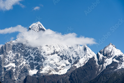 Landscape of Siguniang mountain or Four girls mountains with snow cap on top and  plants,located in Xiaojin County of the Aba Tibetan and Qing Autonomous Prefecture in western Sichuan Province. photo
