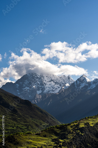 Landscape of Siguniang mountain or Four girls mountains with snow cap on top and plants,located in Xiaojin County of the Aba Tibetan and Qing Autonomous Prefecture in western Sichuan Province.