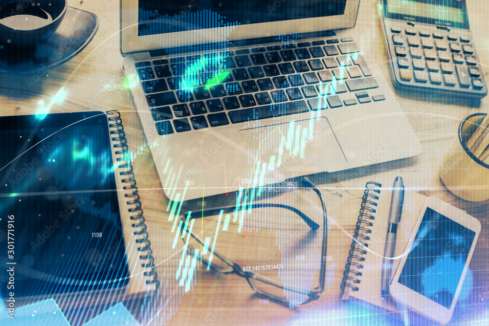 Financial graph colorful drawing and table with computer on background. Double exposure. Concept of international markets. Financial graph colorful drawing and table with computer on background. Double exposure. Concept of international markets.