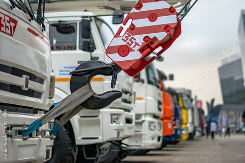 Trucks in a row as construction equipment with a crane and Lifting hook close-up