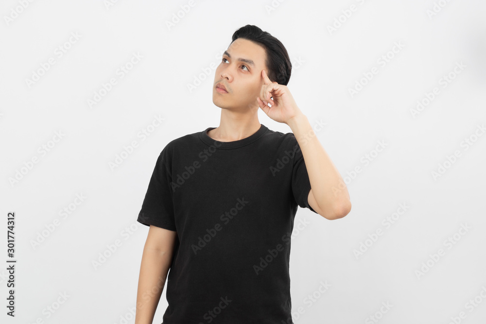 Young asian man with black shirt having doubts and with confuse face expression while scratching head on isolated on white background. Young asian man with black shirt having doubts and with confuse face expression while scratching head on isolated on white background.
