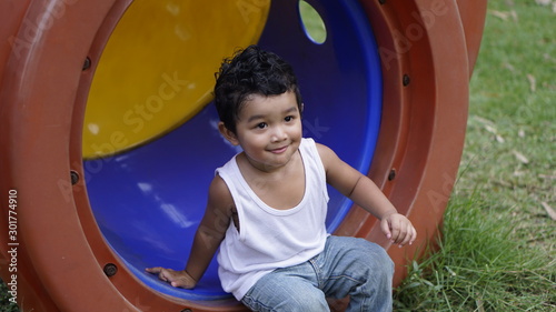 Asian Children 2 year old playing in the garden outdoor holiday kid concept.
