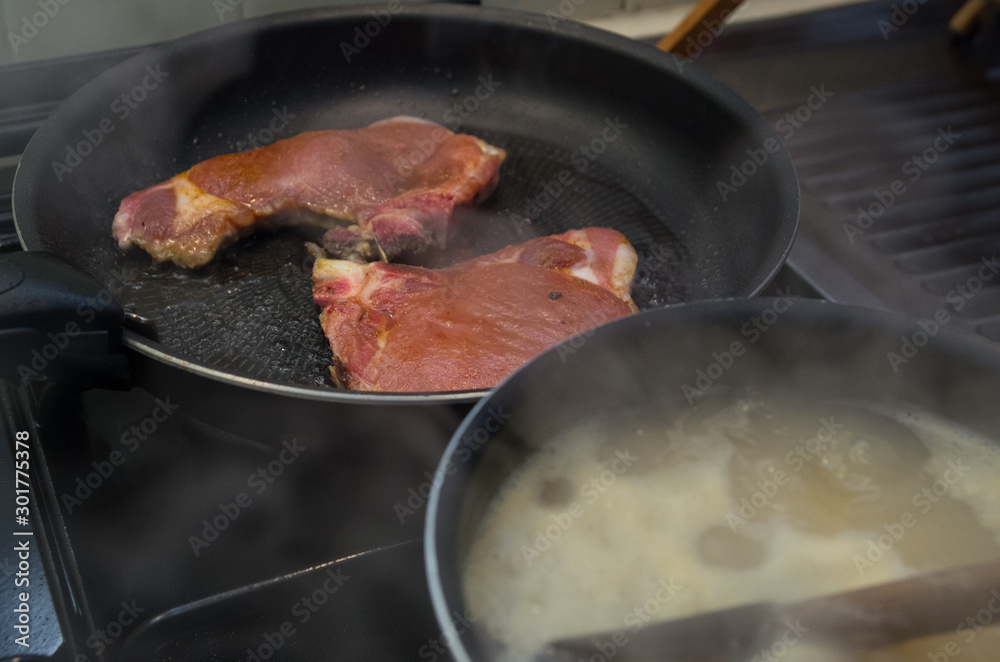 Meat and pastas cooking with pan smoking kitchen Meat and pastas cooking with pan smoking kitchen