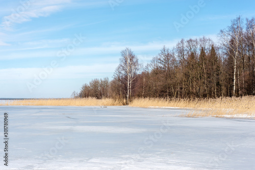 winter landscape of a natural lake covered with snow