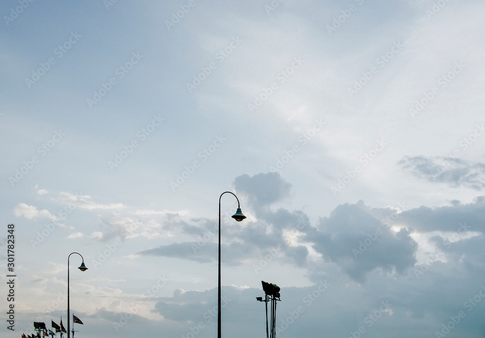 Street lamp lights on empty footpath in evening Street lamp lights on empty footpath in evening