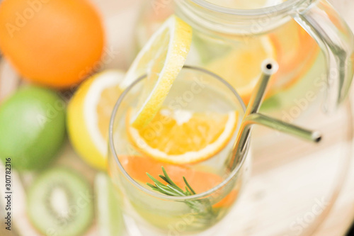 Close up preparing ice cocktail lemonade at hot summer day. Metal straw. Eco friendly picnic on meadow. Reusable 