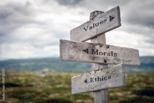 Values, morals and ethics text on wooden sign post outdoors in landscape scenery. Business, quotes and motivational theme concept. photo